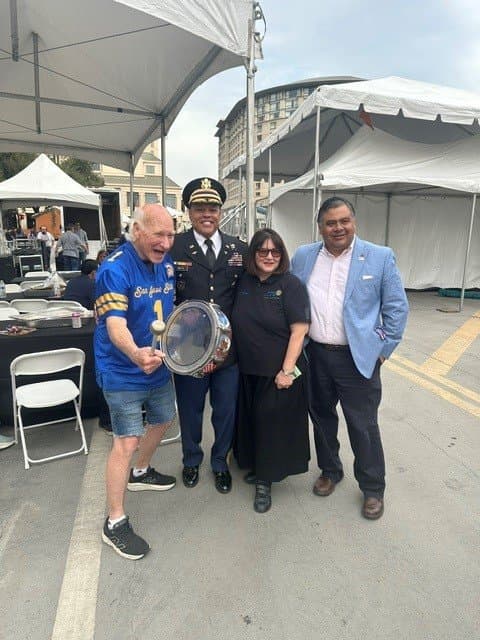 Community leaders and a military officer at the parade